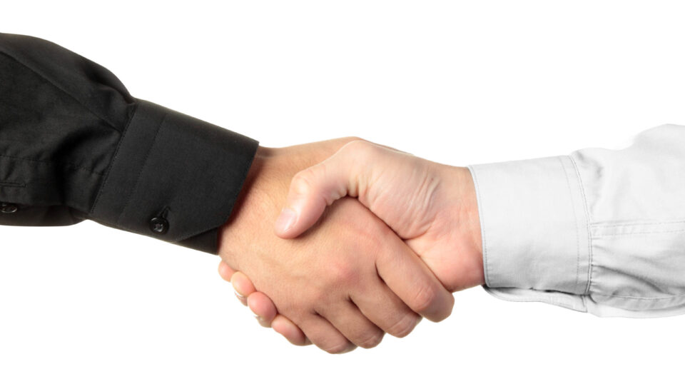 Businessmen shaking hands isolated on white background